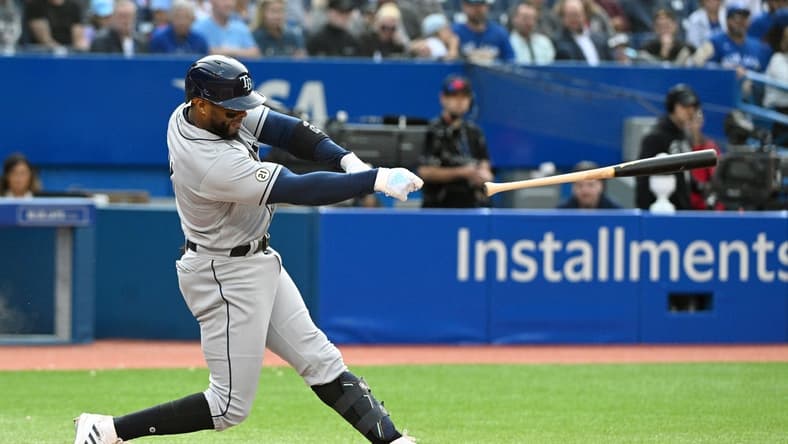 Sep 15, 2022; Toronto, Ontario, CAN; Tampa Bay Rays third baseman Yandy Diaz loses his bat during the seventh inning against the Toronto Blue Jays at Rogers Centre. Mandatory Credit: Dan Hamilton-USA TODAY Sports