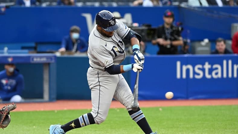 Sep 15, 2022; Toronto, Ontario, CAN; Tampa Bay Rays designated hitter Manuel Margot (13) hits a three RBI double against the Toronto Blue Jays in the ninth inning at Rogers Centre. Mandatory Credit: Dan Hamilton-USA TODAY Sports
