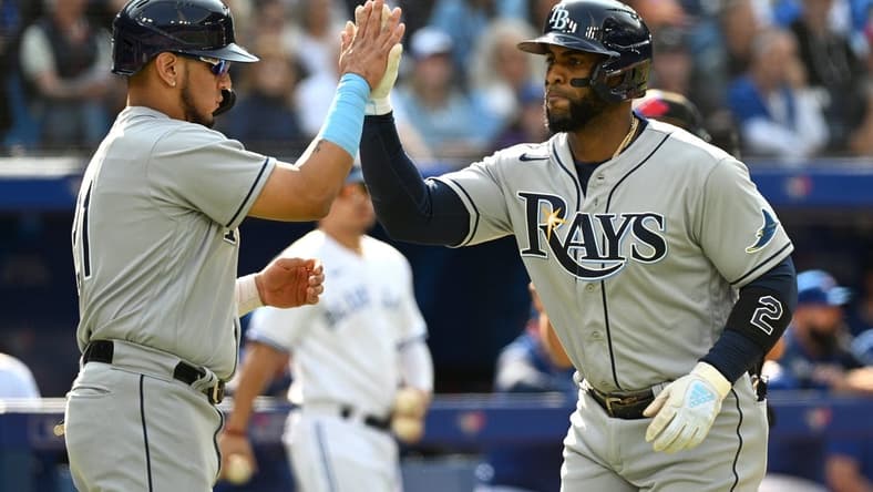 Sep 15, 2022; Toronto, Ontario, CAN; Tampa Bay Rays third baseman Yandy Diaz (2, right) is greeted at home plate by second baseman Isaac Paredes (17) after hitting a three run home run against the Toronto Blue Jays in the second inning at Rogers Centre. Mandatory Credit: Dan Hamilton-USA TODAY Sports