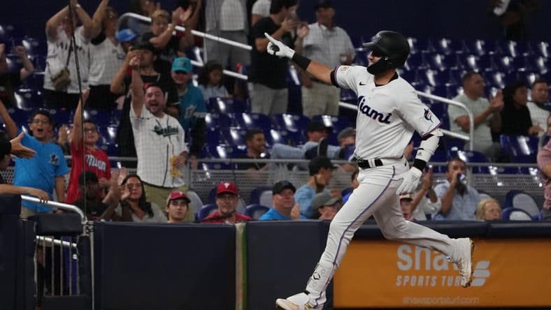 Sep 15, 2022; Miami, Florida, USA; Miami Marlins third baseman Jordan Groshans (65) celebrates while rounding the bases after hitting a solo home run in the third inning against the Philadelphia Phillies at loanDepot park. Mandatory Credit: Jasen Vinlove-USA TODAY Sports