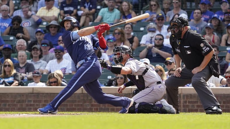Sep 16, 2022; Chicago, Illinois, USA; Chicago Cubs third baseman David Bote (13) hits a single against the Colorado Rockies during the first inning at Wrigley Field. Mandatory Credit: David Banks-USA TODAY Sports