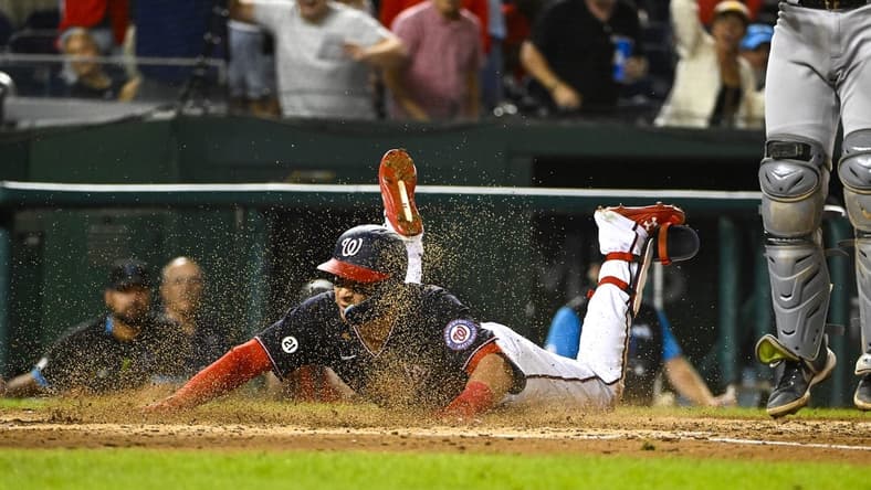 Sep 16, 2022; Washington, District of Columbia, USA; Washington Nationals first baseman Joey Meneses (45) slides into home for a home run against the Miami Marlins during the seventh inning at Nationals Park. Mandatory Credit: Brad Mills-USA TODAY Sports