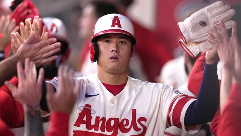 Sep 16, 2022; Anaheim, California, USA; Los Angeles Angels designated hitter Shohei Ohtani (17) is congratulated by teammates after scoring in the first inning against the Seattle Mariners at Angel Stadium. Mandatory Credit: Kirby Lee-USA TODAY Sports