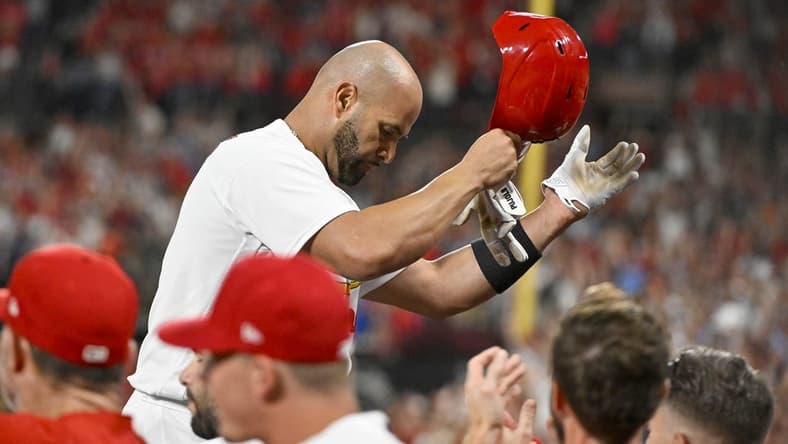 Sep 16, 2022; St. Louis, Missouri, USA; St. Louis Cardinals designated hitter Albert Pujols (5) salutes the fans as he receives a standing ovation after hitting a game tying two run home run for his 698th career home run during the sixth inning against the Cincinnati Reds at Busch Stadium. Mandatory Credit: Jeff Curry-USA TODAY Sports