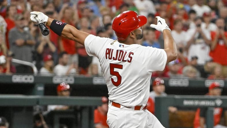 Sep 16, 2022; St. Louis, Missouri, USA;  St. Louis Cardinals designated hitter Albert Pujols (5) hits a game tying two run home run for his 698th career home run during the sixth inning against the Cincinnati Reds at Busch Stadium. Mandatory Credit: Jeff Curry-USA TODAY Sports