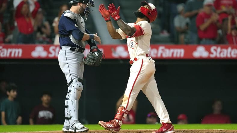 Sep 16, 2022; Anaheim, California, USA; Los Angeles Angels second baseman Luis Rengifo (2) celebrates after hitting a home run in the third inning as Seattle Mariners catcher Curt Casali (5) watches at Angel Stadium. Mandatory Credit: Kirby Lee-USA TODAY Sports