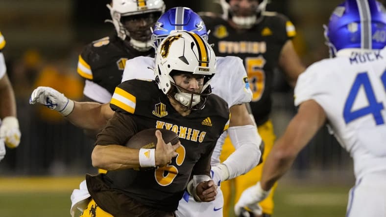 Sep 16, 2022; Laramie, Wyoming, USA; Wyoming Cowboys quarterback Andrew Peasley (6) runs against the Air Force  during the fourth quarter at Jonah Field at War Memorial Stadium. Mandatory Credit: Troy Babbitt-USA TODAY Sports