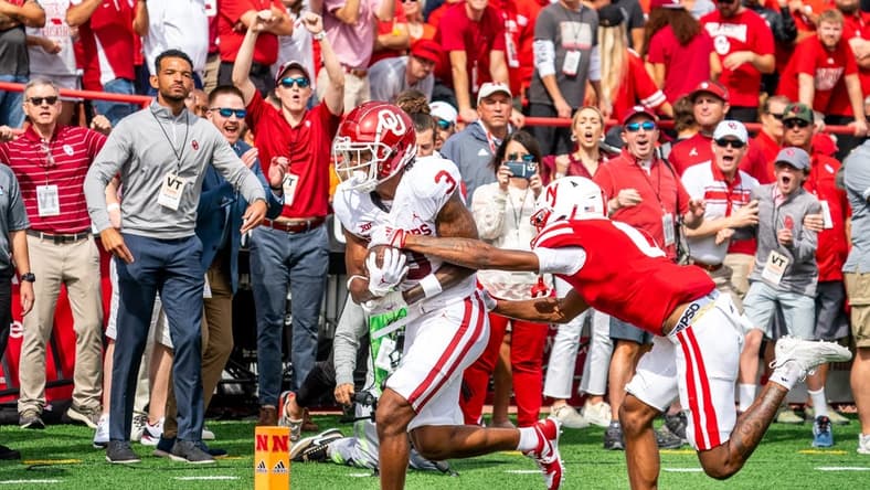 Sep 17, 2022; Lincoln, Nebraska, USA; Oklahoma Sooners wide receiver Jalil Farooq (3) scores a touchdown against Nebraska Cornhuskers defensive back Tommi Hill (0) during the first quarter at Memorial Stadium. Mandatory Credit: Dylan Widger-USA TODAY Sports