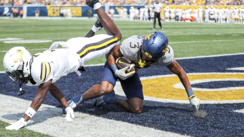 Sep 17, 2022; Morgantown, West Virginia, USA; West Virginia Mountaineers wide receiver Kaden Prather (3) catches a pass for a touchdown during the first quarter against the Towson Tigers at Mountaineer Field at Milan Puskar Stadium. Mandatory Credit: Ben Queen-USA TODAY Sports