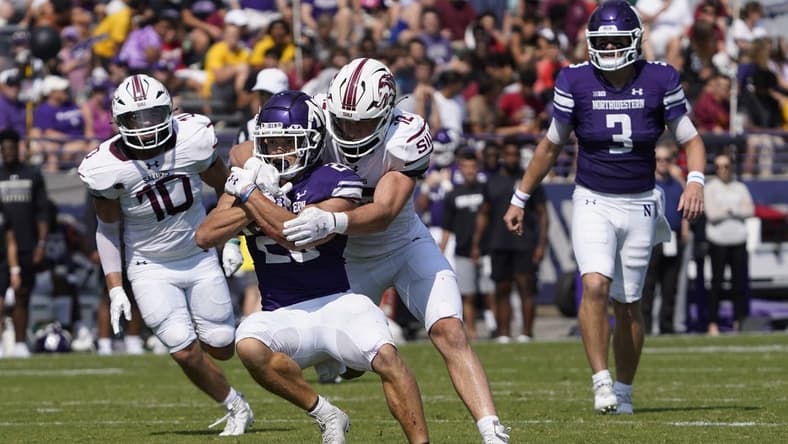 Sep 17, 2022; Evanston, Illinois, USA; Southern Illinois Salukis linebacker Branson Combs (12) tackles Northwestern Wildcats running back Evan Hull (26) during the first half at Ryan Field. Mandatory Credit: David Banks-USA TODAY Sports