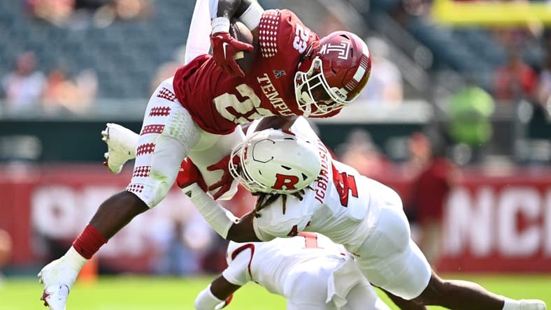 Sep 17, 2022; Philadelphia, Pennsylvania, USA; Rutgers Scarlet Knights defensive back Desmond Igbinosun (4) tackles Temple Owls running back Edward Saydee (23) in the first half at Lincoln Financial Field. Mandatory Credit: Kyle Ross-USA TODAY Sports