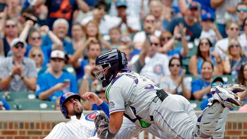 Sep 17, 2022; Chicago, Illinois, USA; Colorado Rockies catcher Elias Diaz (35) tags out Chicago Cubs first baseman Alfonso Rivas (36) at home during the fifth inning at Wrigley Field. Mandatory Credit: Jon Durr-USA TODAY Sports