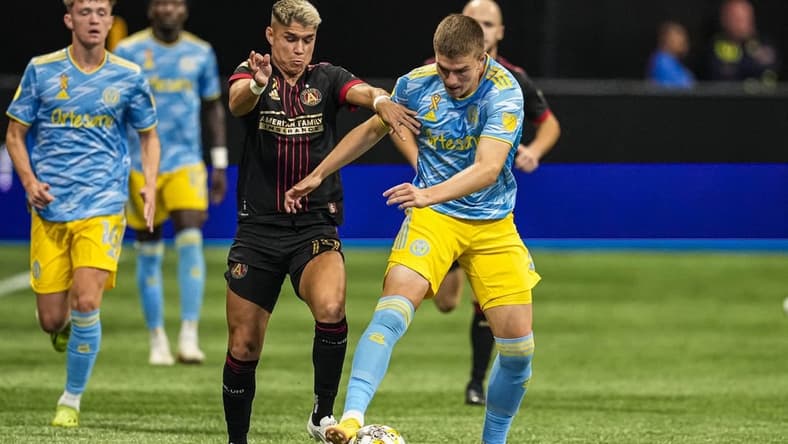 Sep 17, 2022; Atlanta, Georgia, USA; Atlanta United midfielder Luiz Ara  jo (19) tries to prevent Philadelphia Union forward Mikael Uhre (7) from advancing the ball during the first half at Mercedes-Benz Stadium. Mandatory Credit: Dale Zanine-USA TODAY Sports