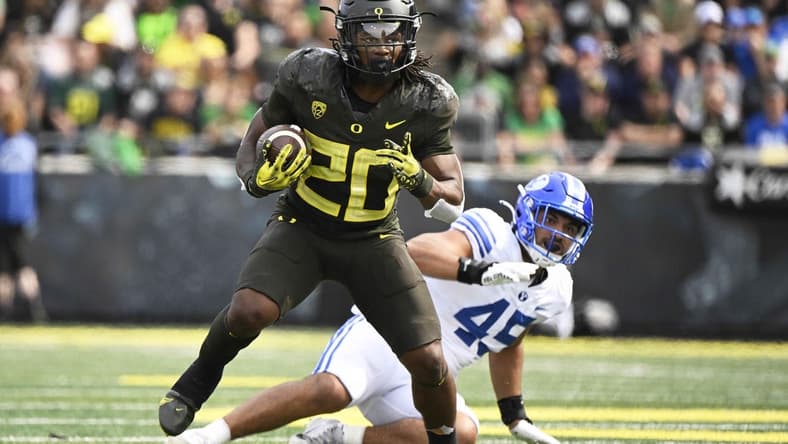 Sep 17, 2022; Eugene, Oregon, USA; Oregon Ducks running back Jordan James (20) breaks away from Brigham Young Cougars defensive lineman Pepe Tanuvasa (45) during the first half for a first down at Autzen Stadium. Mandatory Credit: Troy Wayrynen-USA TODAY Sports