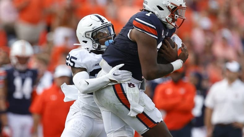 Sep 17, 2022; Auburn, Alabama, USA; Auburn Tigers quarterback T.J. Finley (1) is tackled by Penn State Nittany Lions cornerback Daequan Hardy (25) during the second quarter at Jordan-Hare Stadium. Mandatory Credit: John Reed-USA TODAY Sports