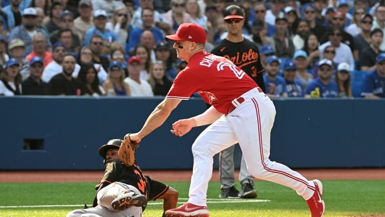 Sep 17, 2022; Toronto, Ontario, CAN;  Toronto Blue Jays third baseman Matt Chapman (26) tags out Baltimore Orioles center fielder Cedric Mullins after a rundown in the fourth inning at Rogers Centre. Mandatory Credit: Dan Hamilton-USA TODAY Sports