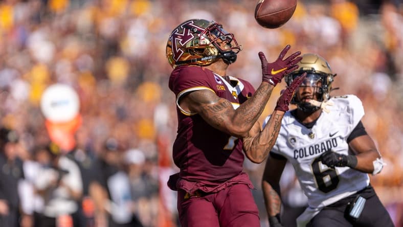 Sep 17, 2022; Minneapolis, Minnesota, USA; Minnesota Golden Gophers wide receiver Chris Autman-Bell (7) catches a 39 yard touchdown pass from quarterback Tanner Morgan (2), Colorado Buffaloes cornerback Nikko Reed (6) cornerback Nikko Reed (6) on defense catches a  at Huntington Bank Stadium. Mandatory Credit: Matt Blewett-USA TODAY Sports