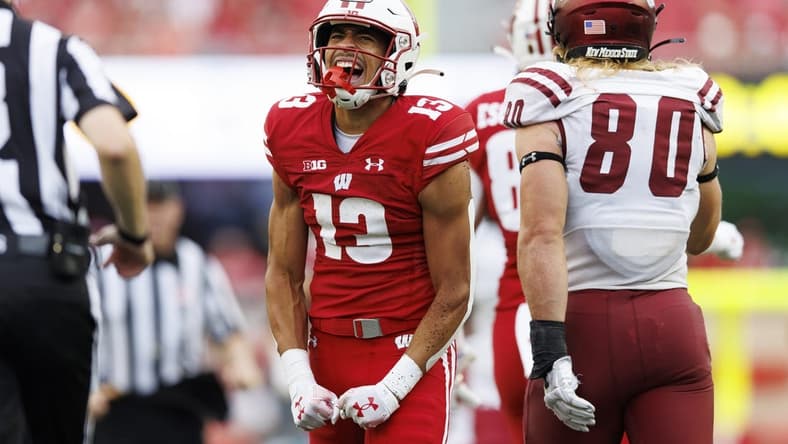 Sep 17, 2022; Madison, Wisconsin, USA; Wisconsin Badgers wide receiver Chimere Dike (13) reacts after catching a pass during the third quarter against the New Mexico State Aggies at Camp Randall Stadium. Mandatory Credit: Jeff Hanisch-USA TODAY Sports