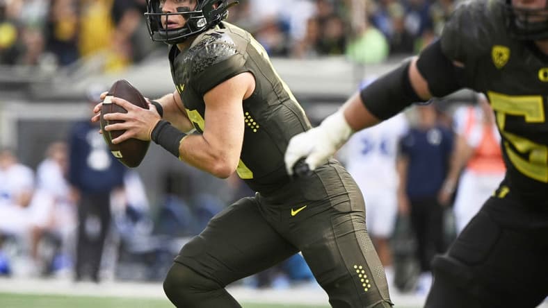 Sep 17, 2022; Eugene, Oregon, USA;  Oregon Ducks quarterback Bo Nix (10) rolls out to pass the ball during the second half against the Brigham Young Cougars at Autzen Stadium. Oregon won the game 41-20. Mandatory Credit: Troy Wayrynen-USA TODAY Sports