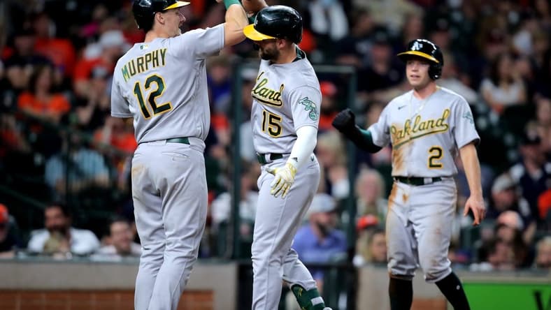 Sep 17, 2022; Houston, Texas, USA; Oakland Athletics right fielder Seth Brown (15) is congratulated by catcher Sean Murphy (12) after hitting a three-run home run to right field against the Houston Astros during the fifth inning at Minute Maid Park. Mandatory Credit: Erik Williams-USA TODAY Sports