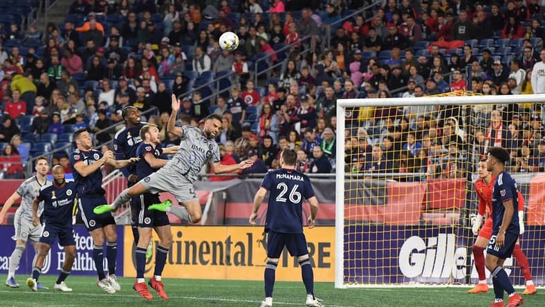 Sep 17, 2022; Foxborough, Massachusetts, USA; CF Montreal defender Rudy Camacho (4) makes a leaping play for the ball  during the first half of a match against against the New England Revolution at Gillette Stadium. Mandatory Credit: Eric Canha-USA TODAY Sports