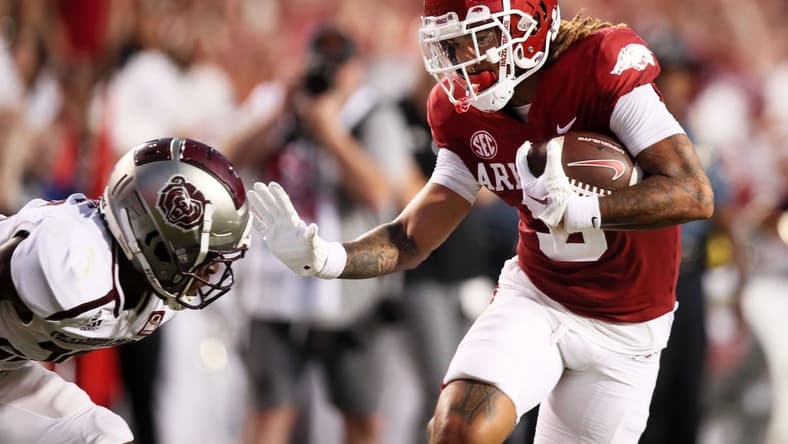 Sep 17, 2022; Fayetteville, Arkansas, USA; Arkansas Razorbacks wide receiver Jadon Haselwood (9) pushes off of a Missouri State Bears defender in the second quarter as he runs after a catch for a touchdown at Donald W. Reynolds Razorback Stadium. Mandatory Credit: Nelson Chenault-USA TODAY Sports