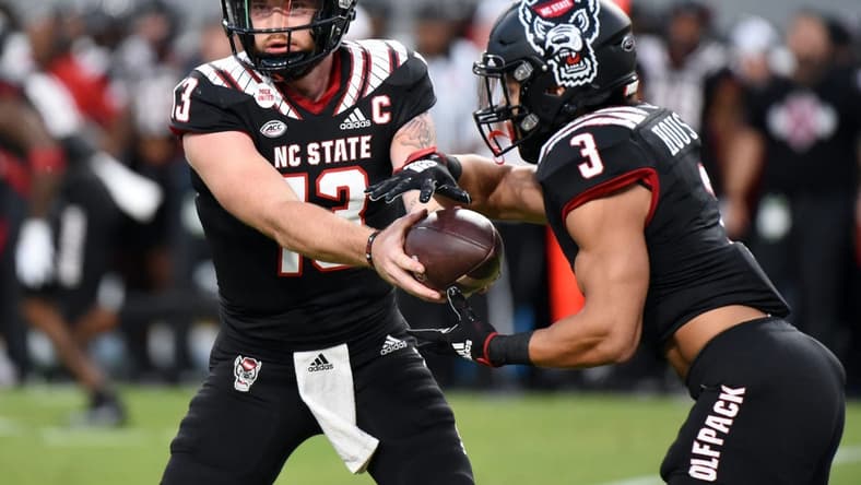 Sep 17, 2022; Raleigh, North Carolina, USA; North Carolina State Wolfpack quarterback Devin Leary (13) hands off to  running back Jordan Houston (3) during the first half against the Texas Tech Red Raiders at Carter-Finley Stadium. Mandatory Credit: Rob Kinnan-USA TODAY Sports