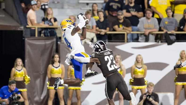 Sep 17, 2022; Kalamazoo, Michigan, USA; Pittsburgh Panthers wide receiver Konata Mumpfield (14) catches a touchdown pass against Western Michigan Broncos cornerback Dorian Jackson (23) in the fourth quarter at Waldo Stadium. Mandatory Credit: Kimberly Moss-USA TODAY Sports