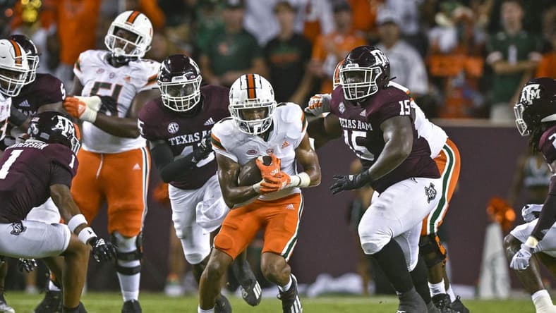 Sep 17, 2022; College Station, Texas, USA; Miami Hurricanes running back Jaylan Knighton (4) runs with the ball against the Texas A&M Aggies during the second quarter at Kyle Field. Mandatory Credit: Jerome Miron-USA TODAY Sports