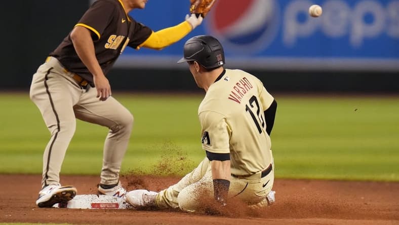 Sep 17, 2022; Phoenix, Arizona, USA; Arizona Diamondbacks' Daulton Varsho (12) slides in safely to second after hitting a double as San Diego Padres infielder Ha-Seong Kim (7) catches the ball at Chase Field. Mandatory Credit: Joe Rondone-Arizona Republic

Mlb Padres At D Backs