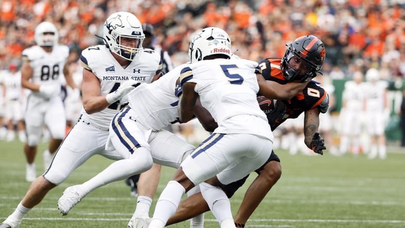 Sep 17, 2022; Portland, Oregon, USA; Oregon State Beavers wide receiver Tre'Shaun Harrison (0) is grabbed by Montana State Bobcats safety Jeffrey Manning Jr. (5) during the first half at Providence Park. Mandatory Credit: Soobum Im-USA TODAY Sports
