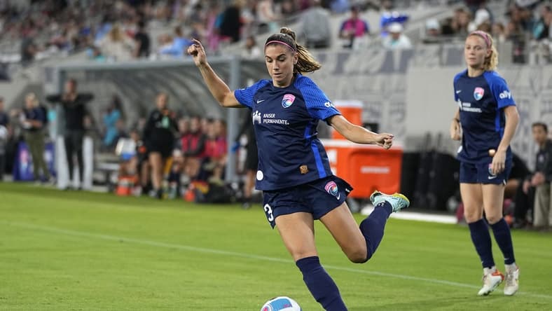 Sep 17, 2022; San Diego, California, USA; San Diego Wave FC forward Alex Morgan (13) passes the ball against Angel City FC in the first half at Snapdragon Stadium. Mandatory Credit: Ray Acevedo-USA TODAY Sports
