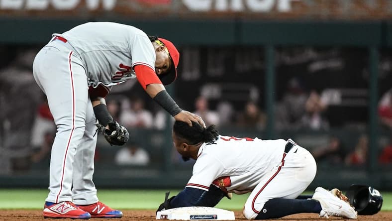 Sep 17, 2022; Cumberland, Georgia, USA; Atlanta Braves second baseman Ozzie Albies (1) is checked on by second baseman Jean Segura (2) after sliding into second against the Philadelphia Phillies in the fourth inning at Truist Park. Mandatory Credit: Larry Robinson-USA TODAY Sports