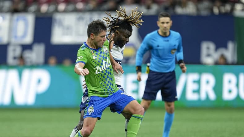 Sep 17, 2022; Vancouver, British Columbia, CAN; Seattle Sounders midfielder Nicolas Lodeiro (10) and Vancouver Whitecaps midfielder Leonard Owusu (17) battle for the ball in the second half at BC Place. Mandatory Credit: Bob Frid-USA TODAY Sports