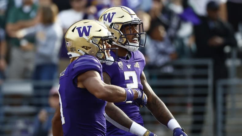 Sep 17, 2022; Seattle, Washington, USA; Washington Huskies wide receiver Ja'Lynn Polk (2) celebrates with wide receiver Rome Odunze (1) after catching a touchdown pass against the Michigan State Spartans during the first quarter at Alaska Airlines Field at Husky Stadium. Mandatory Credit: Joe Nicholson-USA TODAY Sports
