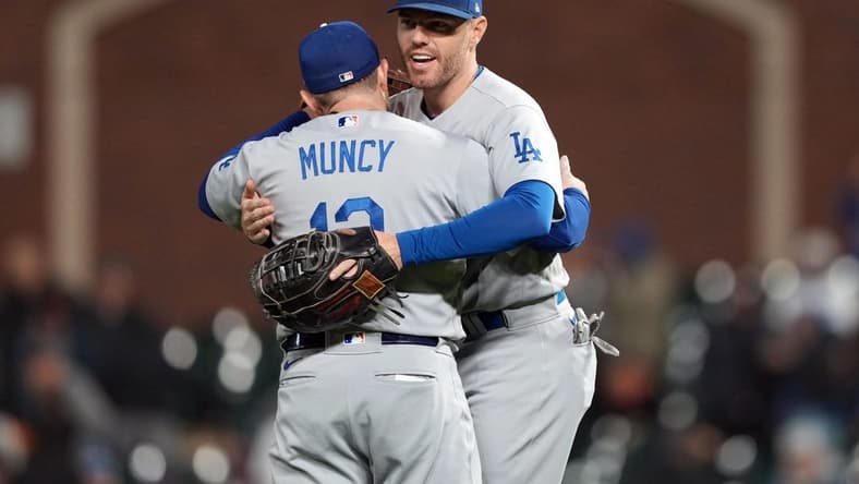 Sep 17, 2022; San Francisco, California, USA; Los Angeles Dodgers third baseman Max Muncy (13) and first baseman Freddie Freeman (5, right) celebrate after defeating the San Francisco Giants at Oracle Park. Mandatory Credit: Darren Yamashita-USA TODAY Sports