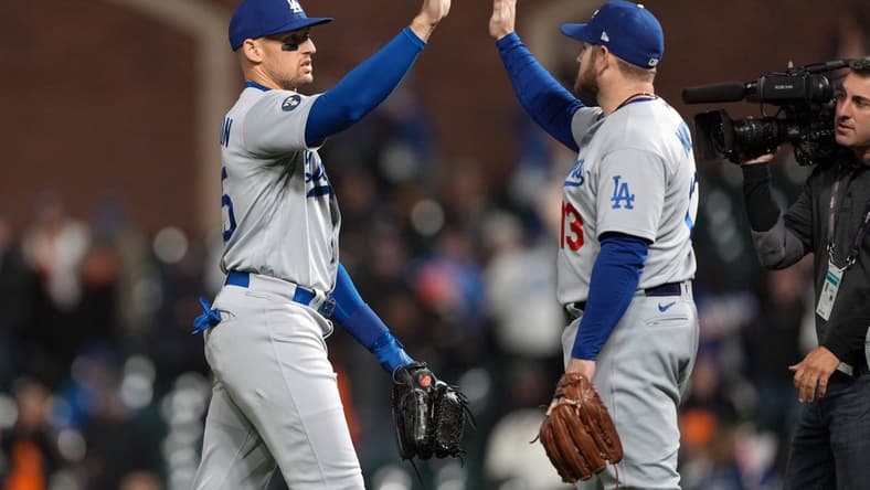 Sep 17, 2022; San Francisco, California, USA; Los Angeles Dodgers center fielder Trayce Thompson (25, left) and third baseman Max Muncy (13, right) celebrate after defeating the San Francisco Giants at Oracle Park. Mandatory Credit: Darren Yamashita-USA TODAY Sports