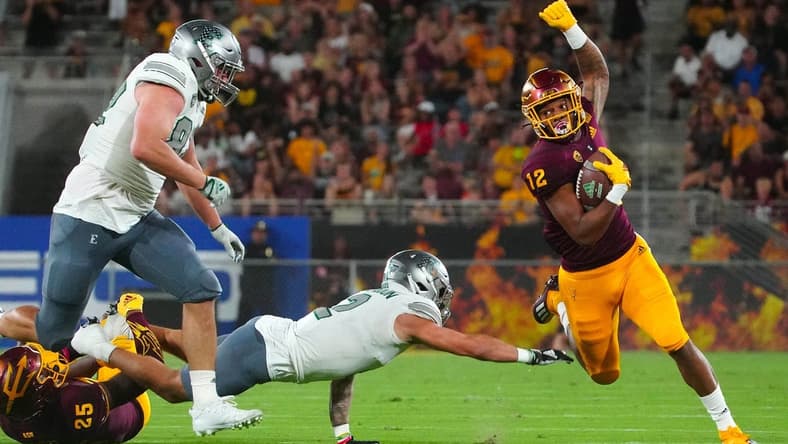 September 17, 2022; Tempe, Arizona; USA; Arizona State Sun Devils defensive back Kejuan Markham (12) returns an interception against the Eastern Michigan Eagles during a game at Sun Devil Stadium. Mandatory Credit: Patrick Breen-USA TODAY Sports