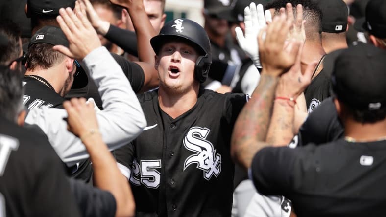 Sep 18, 2022; Detroit, Michigan, USA; Chicago White Sox first baseman Andrew Vaughn (25) high-fives teammates after hitting a grand slam in the fifth inning of the game against the Detroit Tigers at Comerica Park. Mandatory Credit: Brian Sevald-USA TODAY Sports