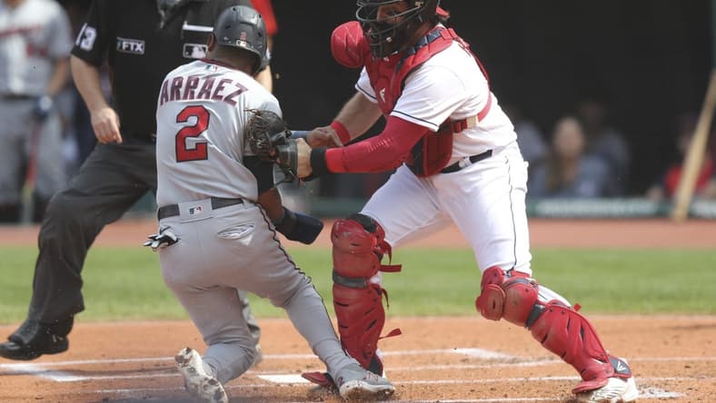 Sep 18, 2022; Cleveland, Ohio, USA; Cleveland Guardians catcher Austin Hedges (17) tags out Minnesota Twins first baseman Luis Arraez (2) at home plate during the first inning at Progressive Field.   Mandatory Credit: Aaron Josefczyk-USA TODAY Sports