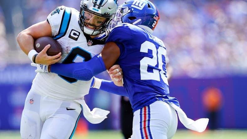 New York Giants safety Julian Love (20) shoves Carolina Panthers quarterback Baker Mayfield (6) out of bounds before the first down in the first half of an NFL game at MetLife Stadium on Sunday, Sept. 18, 2022, in East Rutherford.

Nfl Ny Giants Vs Carolina Panthers Panthers At Giants