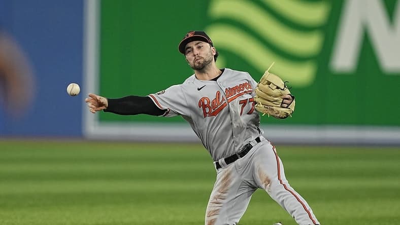 Sep 18, 2022; Toronto, Ontario, CAN; Baltimore Orioles second baseman Terrin Vavra (77) throws to first but can t get out Toronto Blue Jays center fielder Raimel Tapia (not pictured) during the second inning at Rogers Centre. Mandatory Credit: John E. Sokolowski-USA TODAY Sports