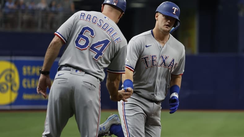 Sep 18, 2022; St. Petersburg, Florida, USA; Texas Rangers third baseman Josh Jung (6) is congratulated by Texas Rangers field coordinator/third base coach Corey Ragsdale (64) after he hit a home run against the Tampa Bay Rays during the second inning at Tropicana Field. Mandatory Credit: Kim Klement-USA TODAY Sports