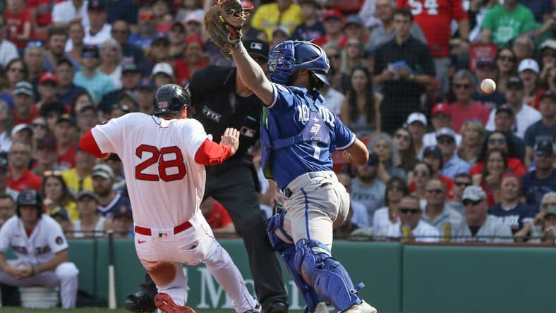 Sep 18, 2022; Boston, Massachusetts, USA; Boston Red Sox designated hitter JD Martinez (28) slides past Kansas City Royals catcher MJ Melendez (1) during the third inning against the Kansas City Royals at Fenway Park. Mandatory Credit: Paul Rutherford-USA TODAY Sports
