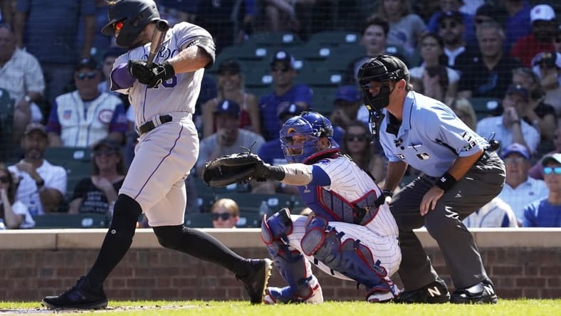 Sep 18, 2022; Chicago, Illinois, USA; Colorado Rockies right fielder Randal Grichuk (15) hits a two-run single against the Chicago Cubs during the first inning at Wrigley Field. Mandatory Credit: David Banks-USA TODAY Sports