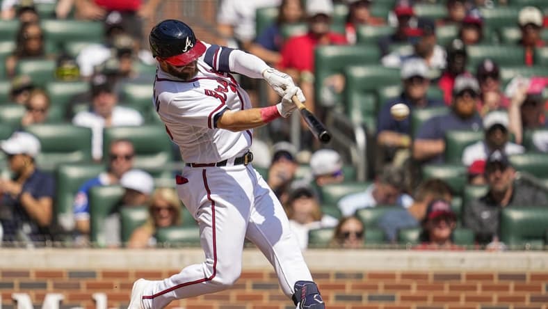 Sep 18, 2022; Cumberland, Georgia, USA; Atlanta Braves left fielder Robbie Grossman (15) hits a single to drive in a run against the Philadelphia Phillies during the third inning at Truist Park. Mandatory Credit: Dale Zanine-USA TODAY Sports