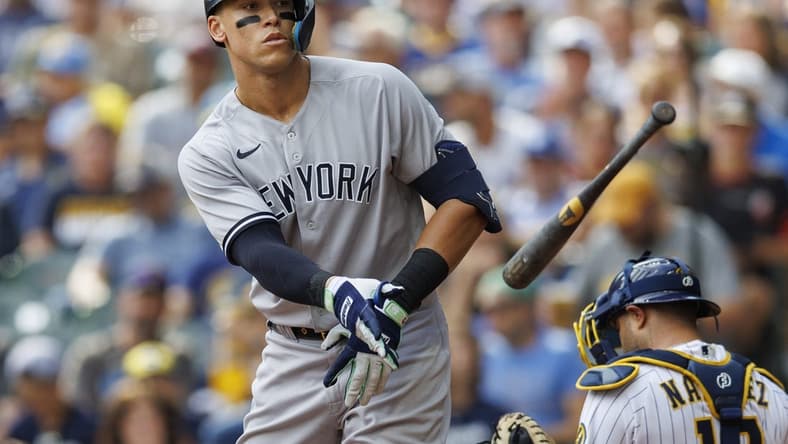 Sep 18, 2022; Milwaukee, Wisconsin, USA;  New York Yankees center fielder Aaron Judge (99) tosses his bat away after drawing a walk during the fifth inning against the Milwaukee Brewers at American Family Field. Mandatory Credit: Jeff Hanisch-USA TODAY Sports