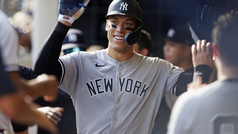 Sep 18, 2022; Milwaukee, Wisconsin, USA; New York Yankees center fielder Aaron Judge (99) celebrates with teammates in the dugout after hitting a home run during the seventh inning against the Milwaukee Brewers at American Family Field. Mandatory Credit: Jeff Hanisch-USA TODAY Sports