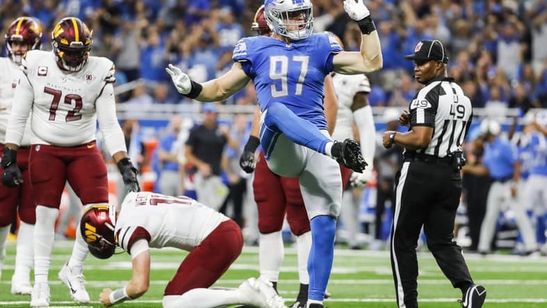 Sep 18, 2022; Detroit, Michigan, USA; Detroit Lions defensive end Aidan Hutchinson (97) celebrates a sack against Washington Commanders quarterback Carson Wentz (11) during the first half at Ford Field. Mandatory Credit: Junfu Han-USA TODAY Sports