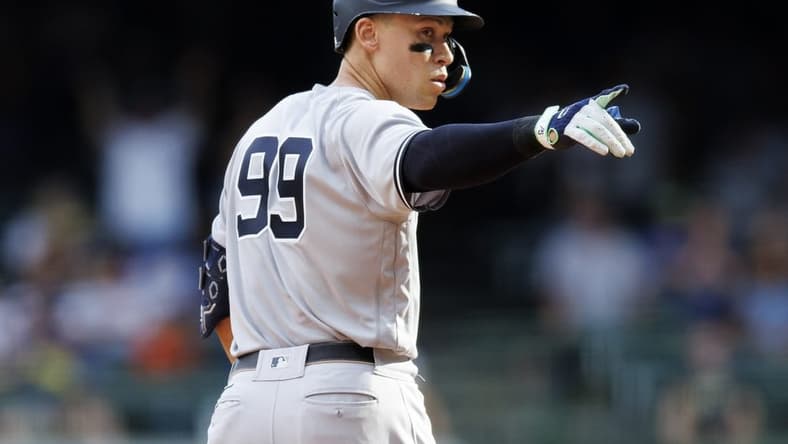 Sep 18, 2022; Milwaukee, Wisconsin, USA; New York Yankees center fielder Aaron Judge (99) gestures after hitting an RBI double during the ninth inning against the Milwaukee Brewers at American Family Field. Mandatory Credit: Jeff Hanisch-USA TODAY Sports